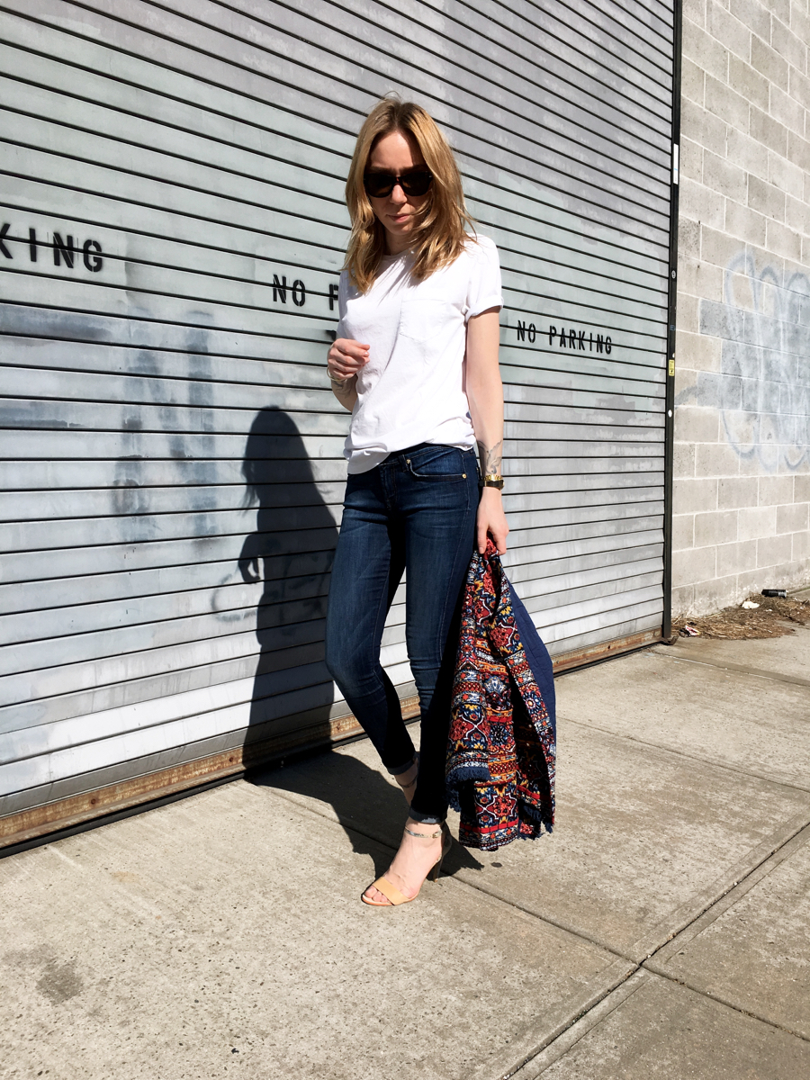 Woman holding embellished jacket for outfit photo