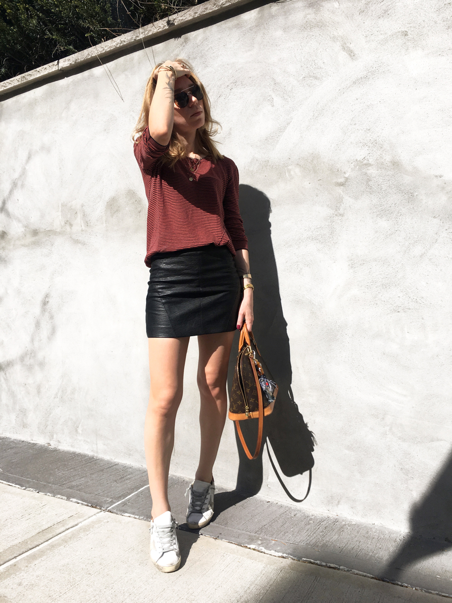 Woman posing in red stripe sweater outfit