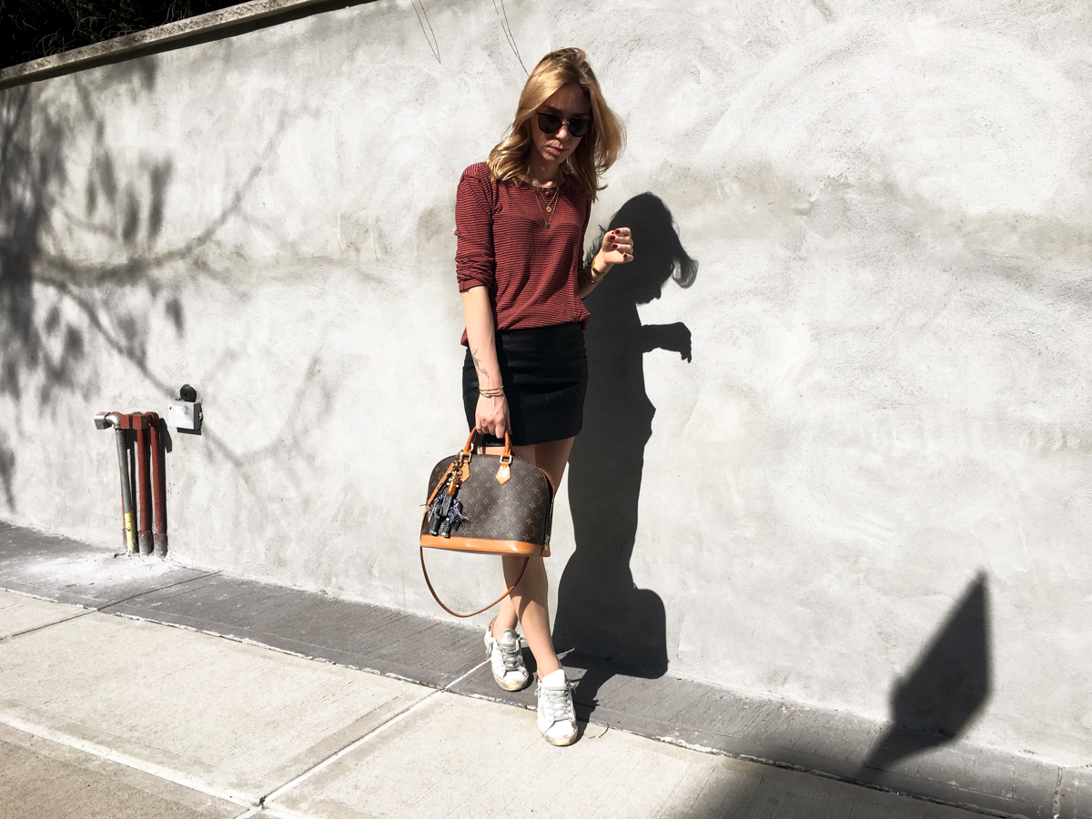 Woman posing in street style photo wearing red stripe sweater