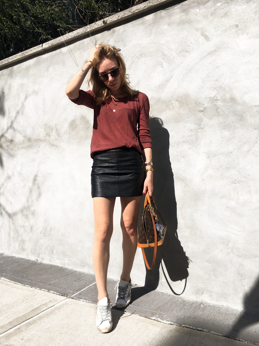 Woman posing in red stripe sweater outfit