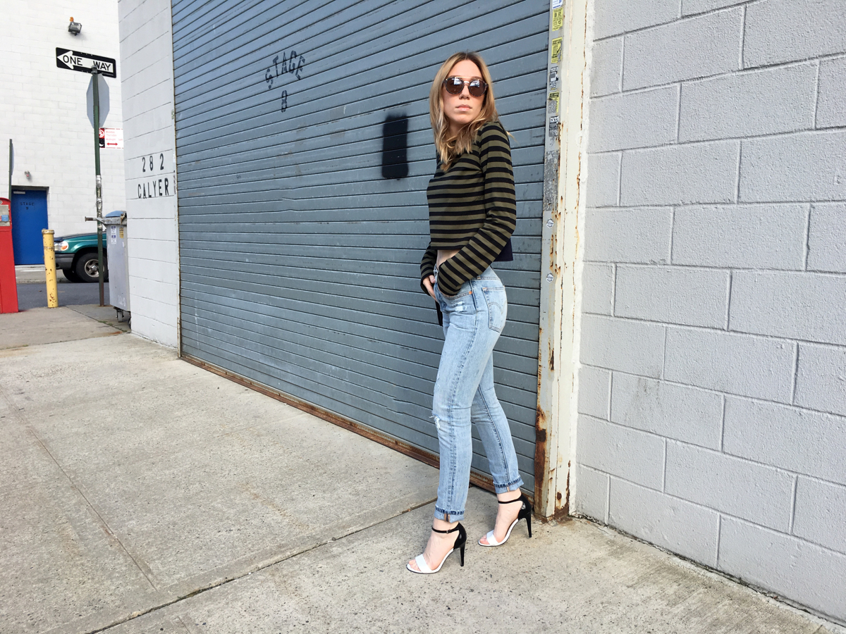 Woman standing sideways in outfit photo