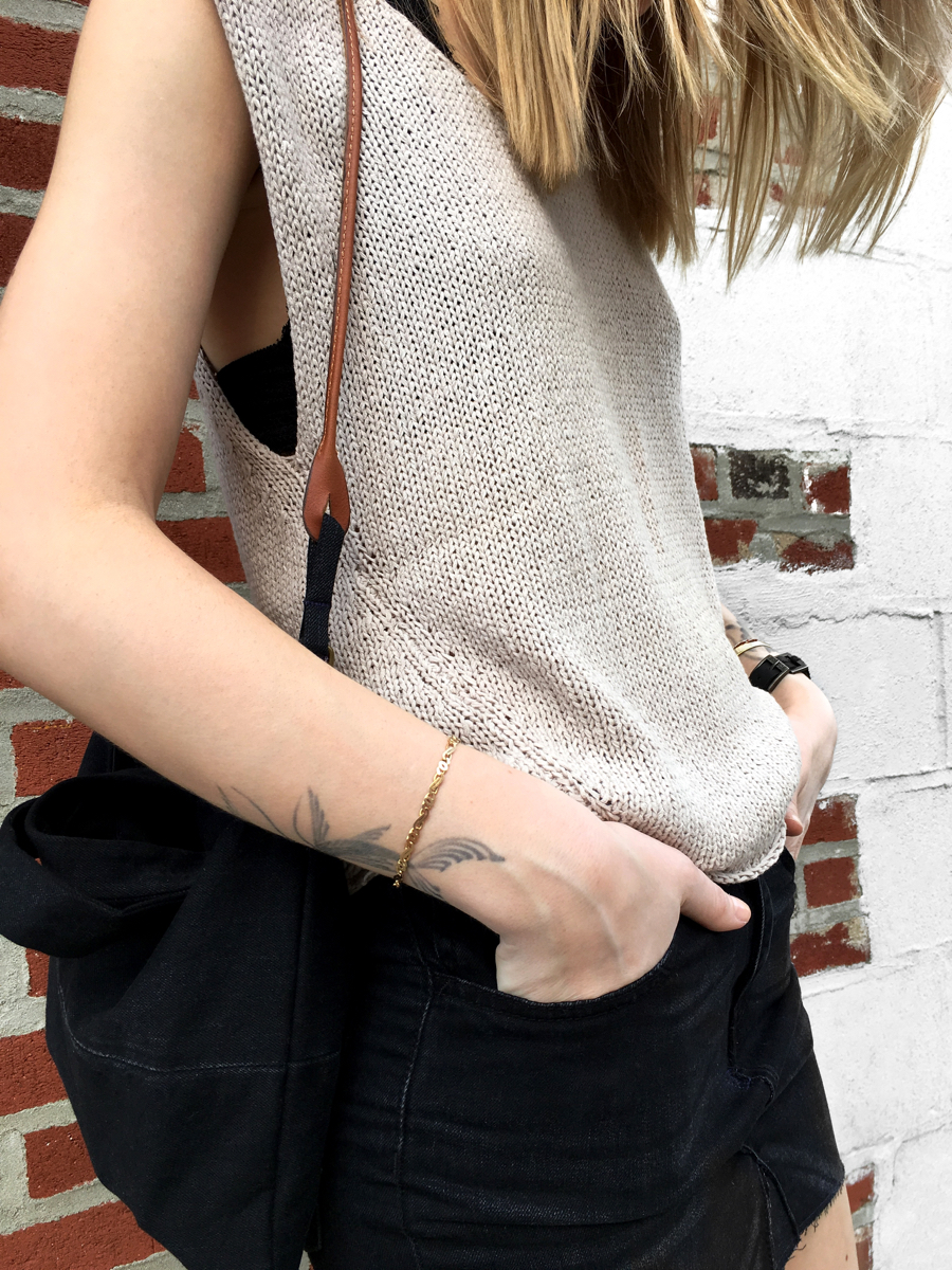 Detail shot of neutral colored knit with black skirt