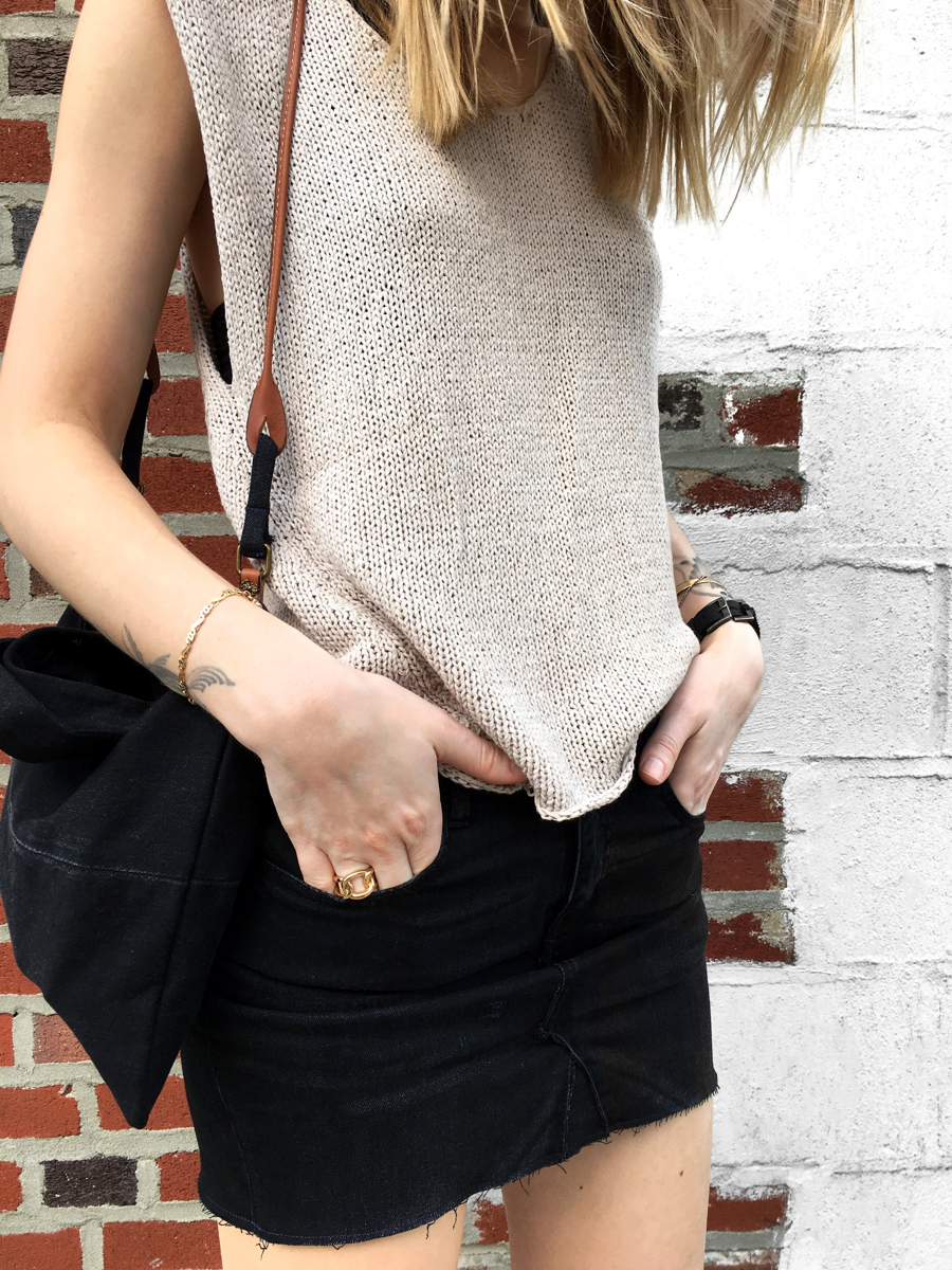 Detail shot neutral knit top and black skirt