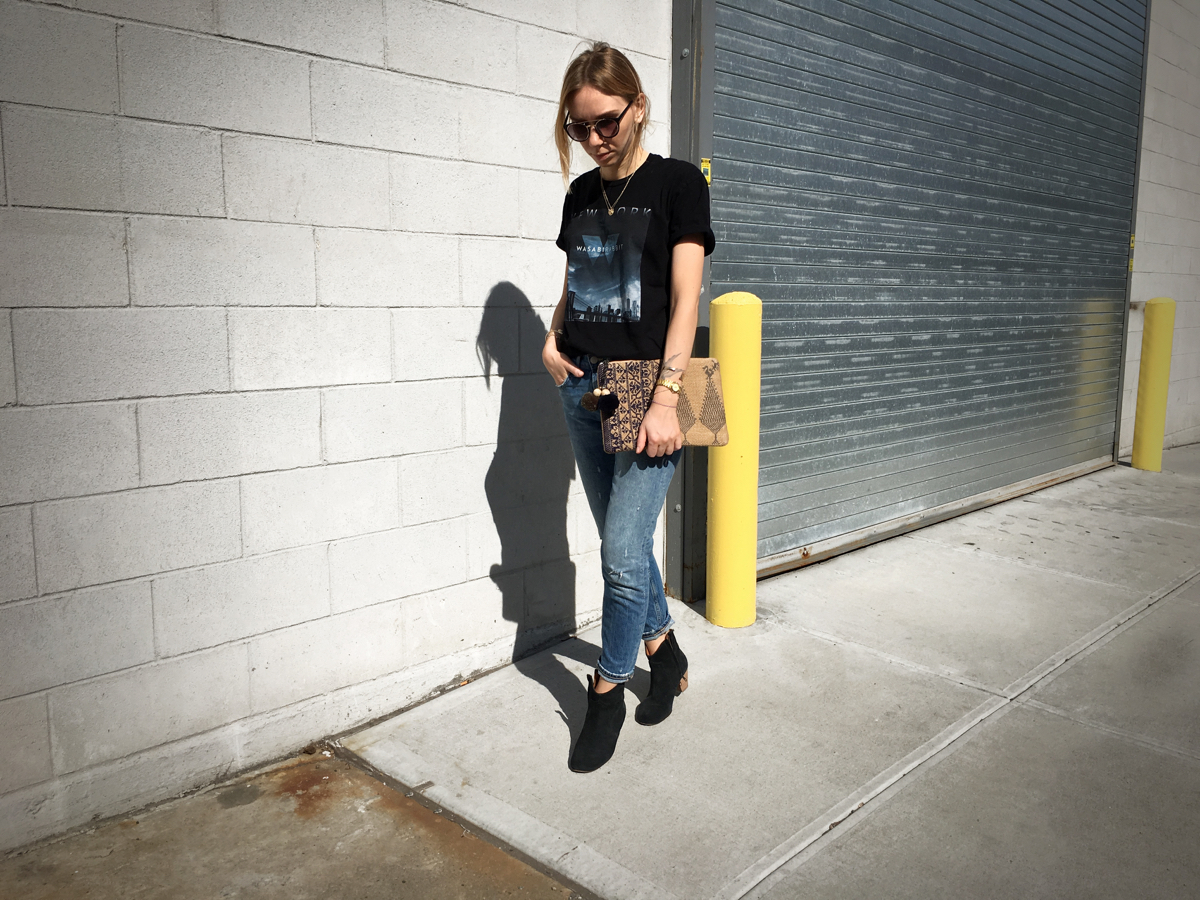 Woman posing in street style photo wearing printed tee