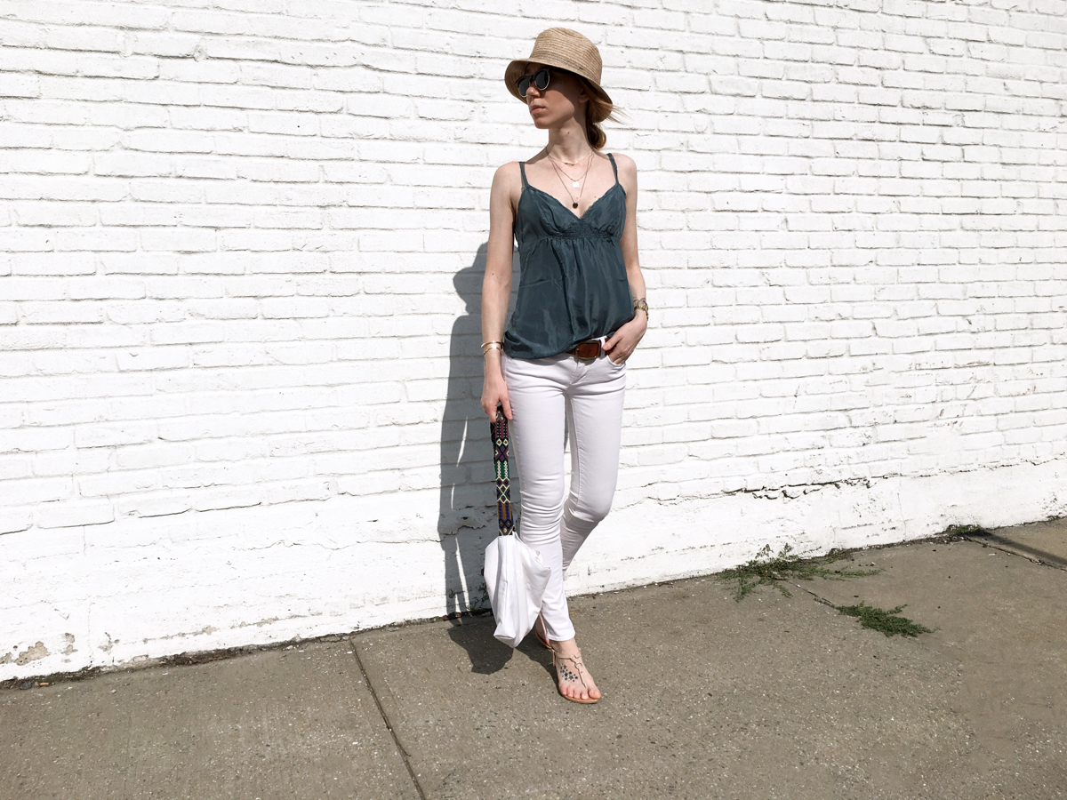 Woman posing against white wall in street style photo
